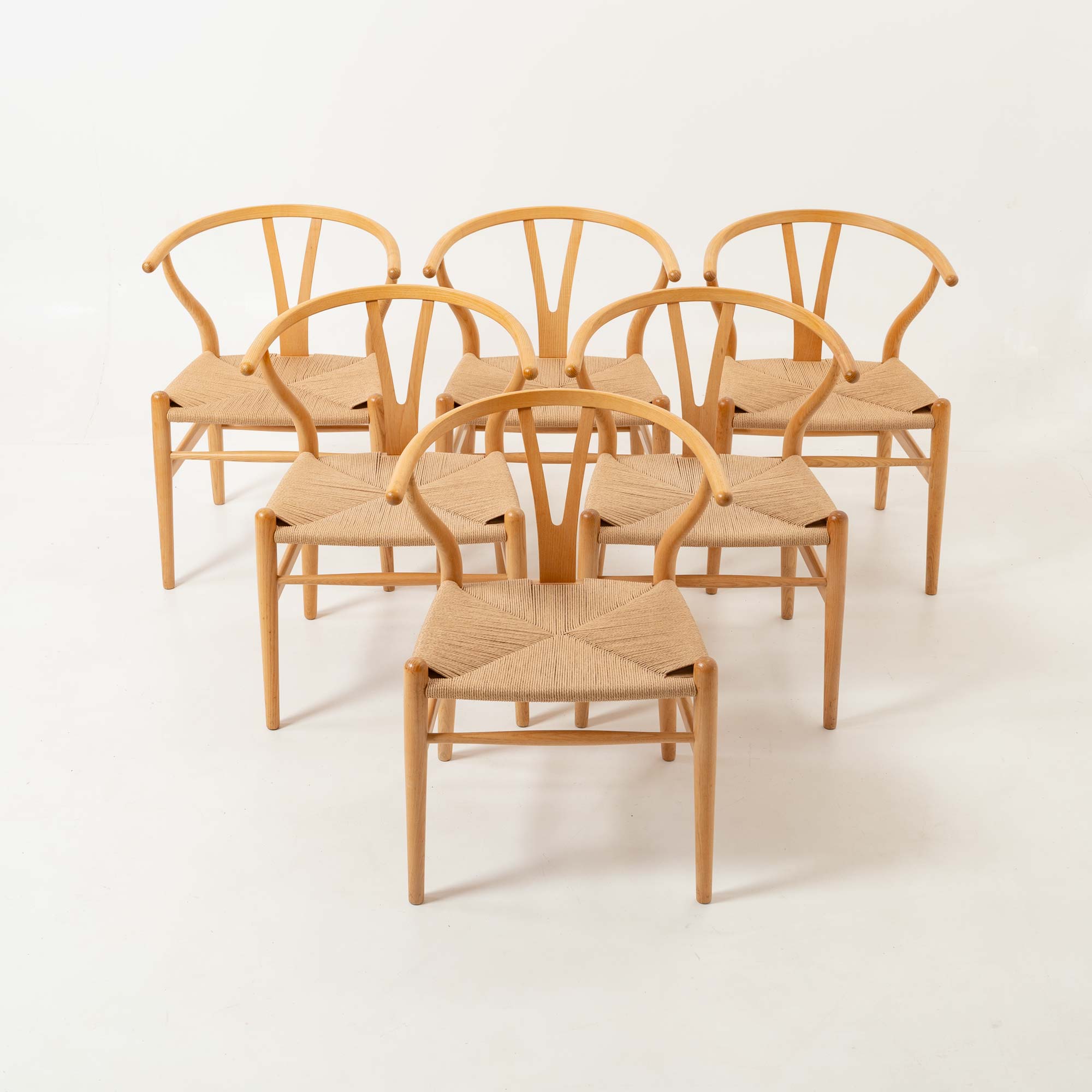 Set of six Hans Wegner for Carl Hansen & Son CH-24  Wishbone Chairs in Oak and Papercord